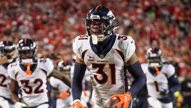 Oct 12, 2023; Kansas City, Missouri, USA; Denver Broncos safety Justin Simmons (31) celebrates after making an interception against the Kansas City Chiefs during the first half at GEHA Field at Arrowhead Stadium.